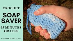 a hand holding a blue crochet soap saver in it's palm