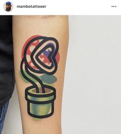 a tattoo on the arm of a person with a potted plant in it's center