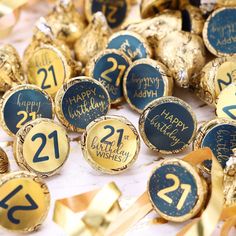 many chocolate candies with the numbers twenty two and twenty three on them, all covered in gold foil