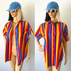 "♥ 80s / 90s Colorful, bright, cheerful wide striped button up short sleeve shirt by BEST AMERICAN.  ♥ NOTE: There is very slight vintage wear in some areas but it is only noticeable on close inspections. You can see some in the close up photo with the buttons. But it's only in certain areas and very hard to notice :) Just letting you know! ♥ Primary colors red, blue, yellow and also navy blue and white. ♥ Nice quality cotton, not too flimsy or too heavy! ♥ Fast FREE Shipping! ♥ Ask for a discount on bundles.  ♥ INSTAGRAM: franzialux_rellickroad MEASUREMENTS (FLAT)  * PIT TO PIT: 23\" (across)  * SLEEVE: 8\" (shoulder seam to end)  * SHOULDERS: 20\" (seam to seam)  * TOTAL LENGTH: 29\"   from the top of shoulder to the longest part of hem. *FIT / SIZE: Labeled Size Small (technically ladie Colorful Vintage Summer Shirt, Fun Summer Button-up Shirt, Retro Multicolor Shirt For Vacation, Colorful Vintage Tops For Summer, Colorful Vintage Summer Tops, Vibrant Button-up Summer Tops, Fun Multicolor Button-up Top, Fun Multicolor Button-up Shirt, Summer Striped Tops With Rainbow Print