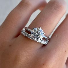 a woman's hand with a ring on it and a diamond in the middle