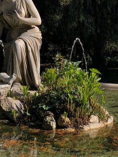 there is a statue in the middle of some water