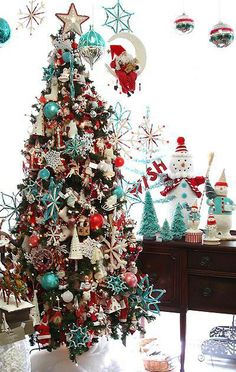 a decorated christmas tree in the corner of a room with other ornaments and decorations around it