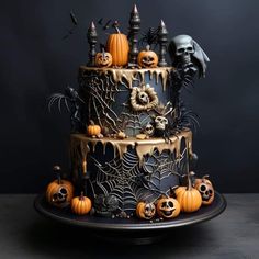 a three tiered cake decorated with halloween decorations