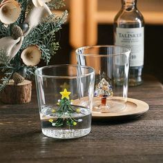 two shot glasses sitting on top of a wooden table