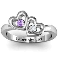 two hearts with names engraved on the side and one heart shaped diamond in the middle