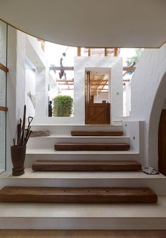 the interior of a house with white walls and wooden steps