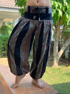 "These super soft rayon baggy unisex harem pants have the \"flow\", perfect of yoga or just a cool strolling. Comfort and character are what these pants are all about. They have the traditional sarong look & feel but a lot more practical when it comes to activity like yoga. As a bonus, they are convertible! Just pull them up and you get yourself a cute jumpsuit in a flash. Together with elastic cuff legs, you can wear them short or long. The pants have smock waist (wide bang elastic) with no Black Bohemian Yoga Pants For Festivals, Bohemian Black Yoga Pants For Festivals, Loose Fit Harem Pants For Yoga And Festivals, Black Cotton Harem Yoga Pants, Black Cotton Harem Pants For Yoga, Traditional Wide Leg Harem Pants For Meditation, Traditional Relaxed Fit Harem Pants For Yoga, Black Hippie Harem Pants For Festival, Traditional Harem Pants For Yoga