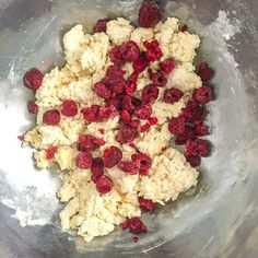 raspberries are mixed together in a metal bowl