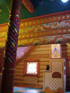 the inside of a house with painted walls and ceilings, including a colorful ceiling design