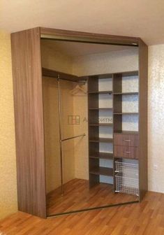 an empty room with wooden floors and shelves