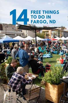 an outdoor event with people sitting at tables and eating food on the grass in front of them