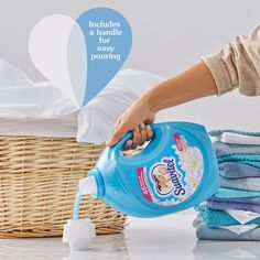 a woman is pouring laundry into a basket