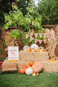 a hay bale with pumpkins and gourds on it