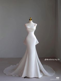 a white wedding dress on display in front of a gray background with the words sewa bridal