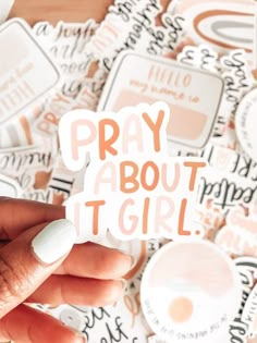 someone holding up a sticker that says pray about it girl in orange and white