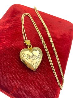 Description: Beautiful vintage 12K gold filled locket.  This locket features an etched heart, an etched flower bloom with leaves and swirling designs on the front.  The fanned bale is decorative and has some nice embellishments that complement the locket front.   The back of the locket is plain with no design. The locket beautiful and is hallmarked WH in one of the wells. This stands for the W&H Jewelry Company of Providence, RI that operated into the 1960s.  There are 2 compartments for photos inside this Retro era gold filled locket that are have the original photo frames, covers and old photos - what look like the originals (circa 1940s).  The right side has a young man with slicked back hair.  The left side have the same man and a young lady, the man appears to be in uniform.  So uniqu Vintage 14k Gold Locket Necklace, Vintage 14k Gold Locket Necklace Stamped 14k, Antique Yellow Gold Necklaces With Hallmark, Heirloom Yellow Gold Necklace With Hallmarks, Vintage Gold Locket Necklace Stamped 14k, Victorian Gold Necklaces With Hallmark, Vintage 14k Gold Locket Necklace With Vintage Charm, Antique Heart-shaped 14k Gold Necklace, Antique Yellow Gold Necklaces For Valentine's Day