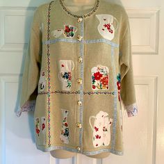 Sweater Weather Will Be Here Before We Know It. Be Prepared With This Adorable Nwot Storybook Knits Button-Up Cardigan. Teapot Buttons On The Front Are Decorative- Real Buttons Are Hidden Behind Them With One Snap At The Neck. There Is A Little Pull On The Back (Pictured) Otherwise Excellent Condition. Too Many Beautiful Details To Show Them All! Color Is Light-Greenish Tan. Storybook Knits, Knits Sweaters, Back Pictures, Garment Bags, Rain And Snow Boots, Sweater Weather, Colorful Sweaters, Trending Accessories, Jean Coat