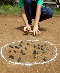 a person kneeling down in front of a circle with balls on it