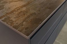 a close up of a counter top in a kitchen with tile flooring and gray cabinets