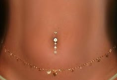 a woman's stomach with gold jewelry on it