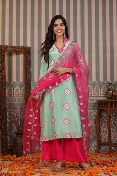 A timeless wardrobe essential, this mint green suit set is crafted from muslin fabric and features handwork that is sure to captivate. Accompanied with an organza dupatta, this set exudes elegance and sophistication. Relaxed enough for every day and luxurious enough for special occasions, this is an exclusive piece that will never go out of style. No. of pieces - 3 piece set. Color - Green and Pink. Fabric - Muslin. Washing Instructions - Dry Clean. Timeless Wardrobe, Green Suit, Organza Dupatta, Muslin Fabric, Green And Pink, Suit Set, Womens Size Chart, Pink Fabric, Out Of Style