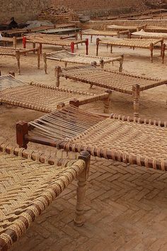 an outdoor seating area with woven seats and tables