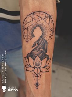 a woman's leg with a tattoo on it that has an image of a buddha