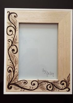 a wooden frame with an intricate design on the front and sides, which reads byjeen