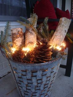 a basket filled with pine cones and lit candles