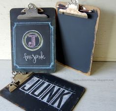 two chalkboard clipboards with magnets attached to them, one has a name tag and the other is a small black board