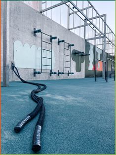 a hose laying on the ground in front of a building