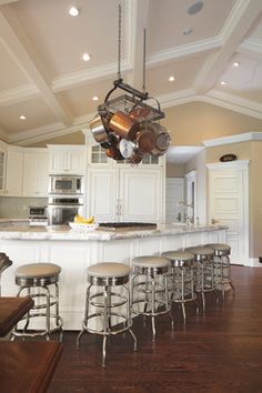 a kitchen with an island and lots of stools