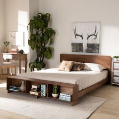 a bed sitting in a bedroom next to a table with drawers on top of it