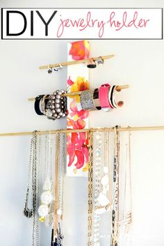 the diy jewelry holder is hanging on the wall