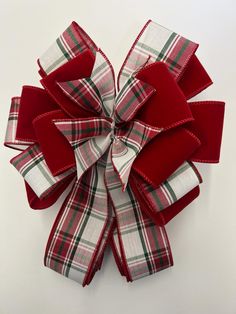 a red and white plaid bow on a white background