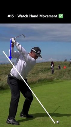 a man swinging a golf club on top of a green field