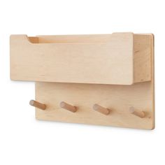 a wooden shelf with three pegs on it