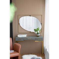 a room with a mirror, table and chair in it