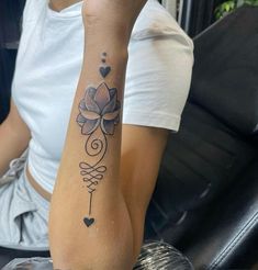 a woman with a lotus tattoo on her arm