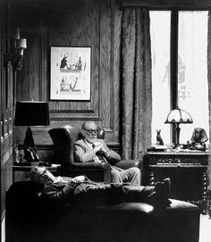 black and white photograph of an old man sitting in a chair