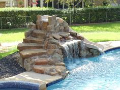 a small pool with a waterfall next to it