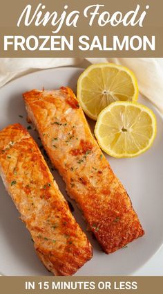 two salmon fillets on a white plate with lemons