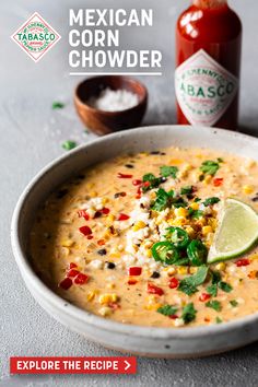 the mexican corn chowder is served in a bowl with a lime slice on top