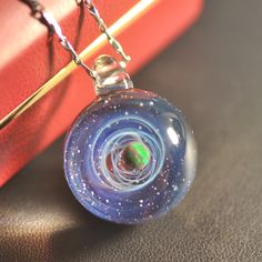 "After purchase, send the phone number to me because the post office needs it so that it can be reached faster The variation is the color of the bottom Please choose PayPal to pay when you purchase, otherwise you can't pay Glass pendant measures approximately 0.86-0.95\" (2.2-2.4 cm) in diameter. 1.2\"(3 cm) in height The glass pendant comes with a brown cord . (Adjustable the length of black cord via he wooden bead.) This charming necklace will arrive at your home securely nestled come in a gif Blue Round Necklace For Birthday Gift, Blue Jewelry For Birthday Gift, Blue Luminous Jewelry For Gifts, Round Blue Glass Jewelry, Handmade Blue Jewelry For Birthday Gift, Blue Round Glass Necklaces, Blue Glass Round Necklaces, Galaxy Pendant, Blue Galaxy