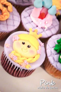 cupcakes decorated with icing and fondant designs