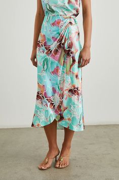 The Sampha Skirt blends vibrant tropical-inspired hues with a flowing faux-wrap silhouette. Complete with an elasticated waistband and a D-ring closure made from faux horn, it offers a chic and summery aesthetic. 55% Rayon 45% Viscose Denim Sweater Jacket, Spring Denim, Spring Knits, Fall Denim, Satin Midi Skirt, Cocktail Evening Dresses, Black Wedding Dresses, Crop Top Sweater, Satin Skirt