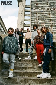 a group of young men standing on top of stairs