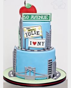 a blue cake with an apple on top that reads 50 avenue and the words yule in my heart