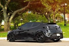 a black sports car parked on the side of the road